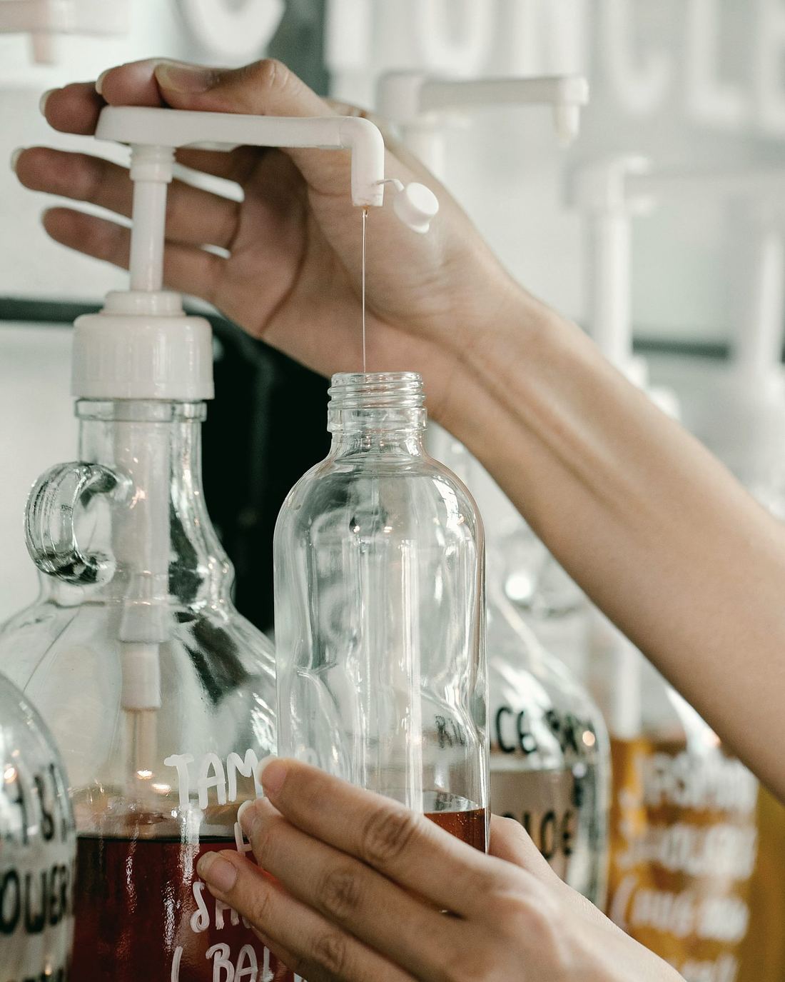 Amber fragrance concentrate being decanted into a sample bottle at Velmora